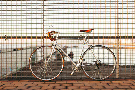 Vintage bicycle against a fence.