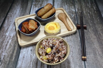 Traditional cooked jasmine rice with fresh gingko, dried shrimp, red bean and mixed grained on the bowl. Famous healthy and high nutrition menu in Asia restaurant. Selective focus concept.