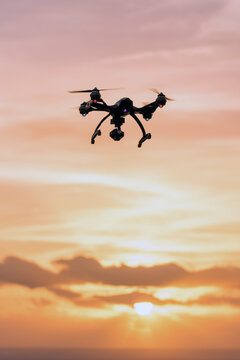 Drone flying in the cloudy sunset