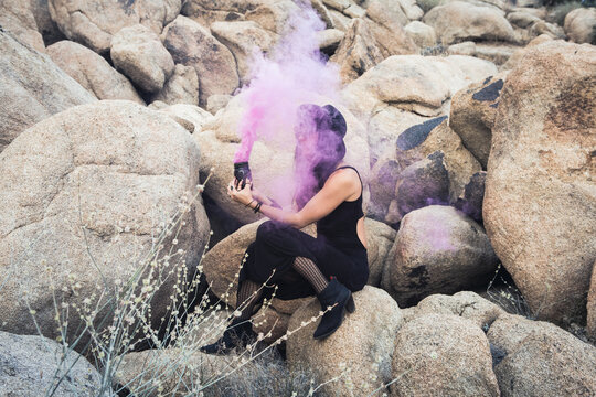 Witchy Woman with Purple Smoke and Desert Rocks