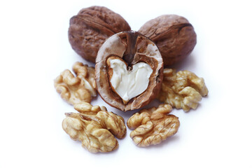 Whole and cracked walnuts isolated on white background