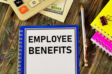 Employee benefits - text inscription in the planning form on the background of office supplies....