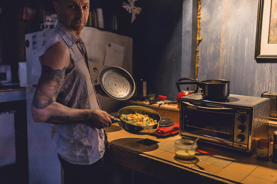A tattooed artist in his ramshackle home.
