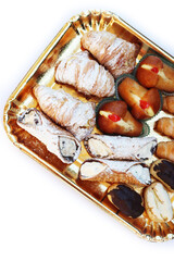 Traditional assortment of italian pastries on golden tray. Cannoli, Babà, Bignet and cannoli with cream