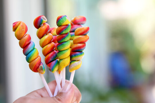 Hand holding candy lollipops