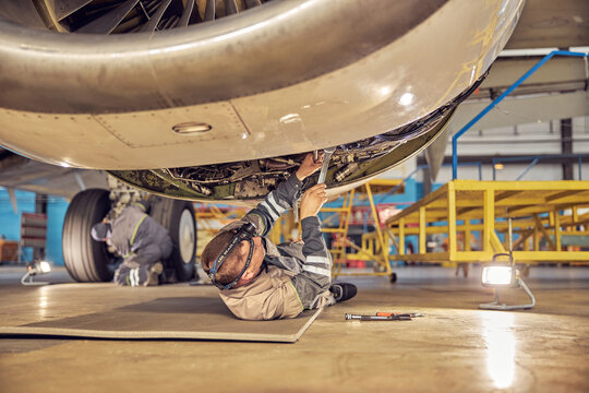 Mechanic installing reverse hoods in the hangar