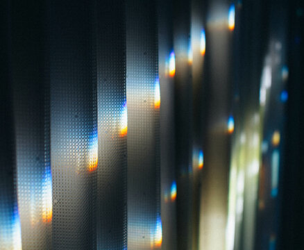 Prisms of light reflected on lace curtains