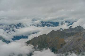 Fototapeta na wymiar The mountain landscape with clouds around in Dagu glacier park in Sichuan, China.