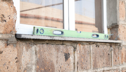 Level on window in outdoor. Repairing