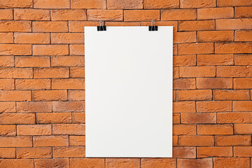 Blank poster hanging on brick wall