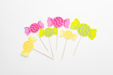 Stylish cupcake toppers on white background