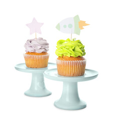 Tasty cupcakes with stylish toppers on white background