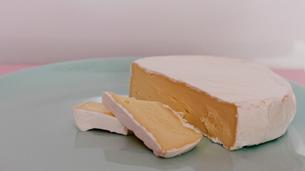 Camembert cheese on a mint plate.