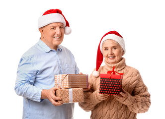 Elderly couple with Christmas gifts on white background