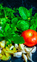 Fresh vegetables stacked together on a black table