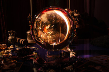 Beautiful crystal orb in a fortune teller's room. Glass ball. Occult symbol