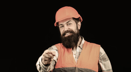 Portrait of a builder smiling. Bearded man worker with beard in building helmet or hard hat. Man builders, industry