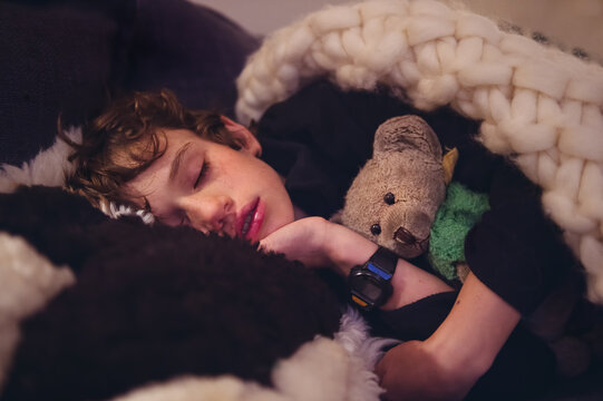 Naklejki Close up of a sleeping boy and his teddy bear
