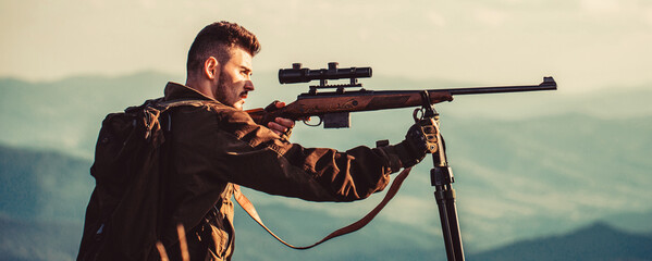 Hunting period. Male with a gun. Hunter with hunting gun and hunting form to hunt. Hunter is...