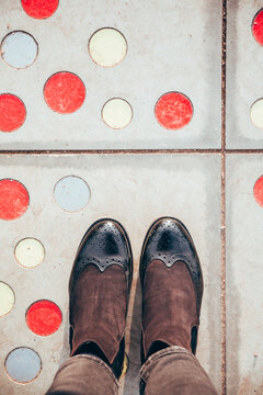 Woman feet, on colored dots floor