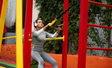 A young woman exercising with athletic loops