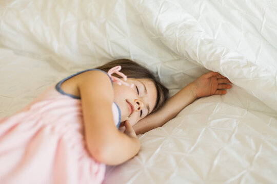 A child napping in a bright room