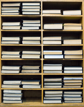 Orderly stacked books on a bookshelf