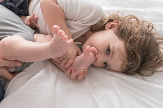 A Girl Kissing Her Sibling's Feet