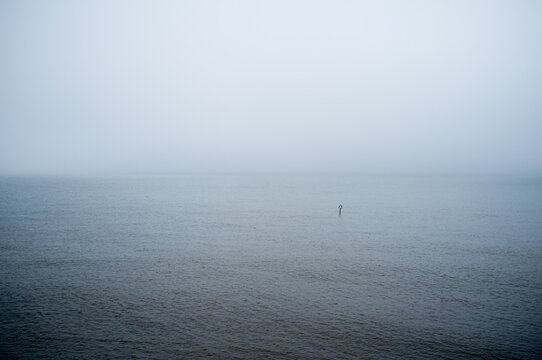 An object floating in a fog engulfed sea