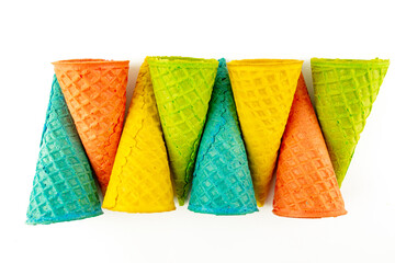 Set of various bright multicolored ice-cream waffle cones on white background .