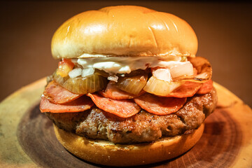 hamburger wooden background whit pepperoni and onions