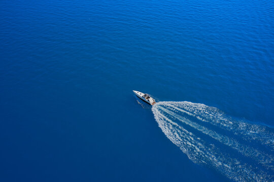 Drone view of a boat  the blue clear waters. Travel - image. Large speed boat moving at high speed side view