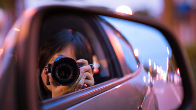 Asian girl in a car and making selfie