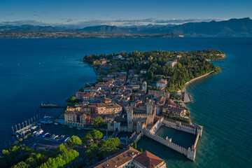 Fototapeta premium Aerial view on Sirmione sul Garda. Italy, Lombardy. Rocca Scaligera Castle in Sirmione. View by Drone early in the morning