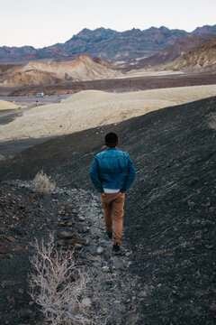 young man walking through national park at sunrise