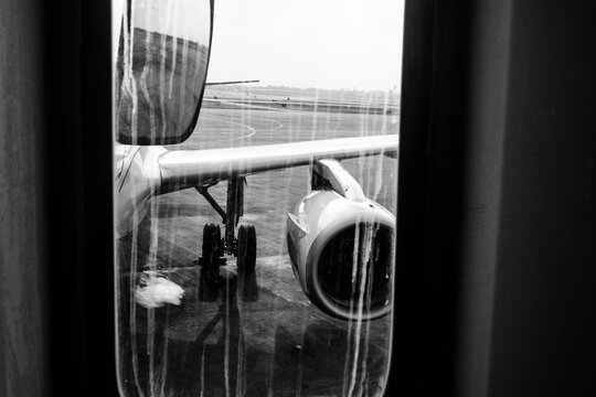 Airplane jet engine as seen from the tube's dirty window