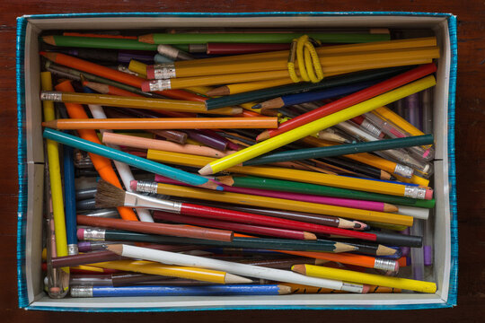 Discarded Pens And Pencils In A Shoebox Shot From Above