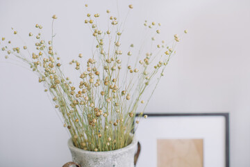 Field Flowers in vase agains gray wall Copy space, home decor concept.