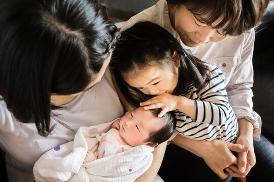 Three generation Asian family with a newborn baby