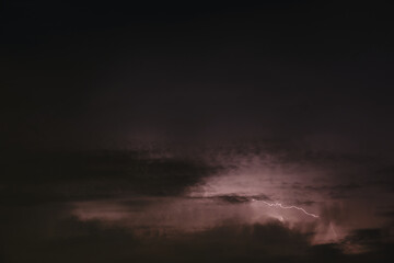 Fototapeta na wymiar Lightning in the night sky. Lightning trail in the sky