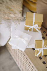 Gift boxes with ribbons in modern interior. Gifts packaging concept, copy space.