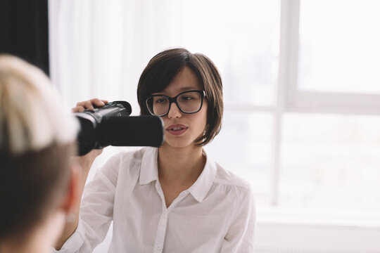 young women shooting home video