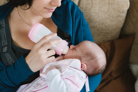 Mother with cute newborn girl moment