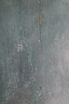 Pitted cracked surface on a wooden panel