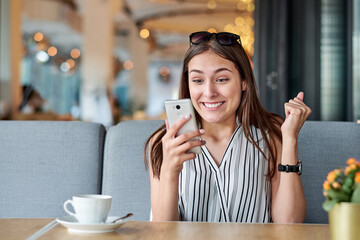 Wow effect, woman enjoying a good message on the phone. Emotions, surprise, delight.