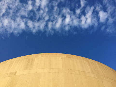 Low angle view of modern building exterior and sky