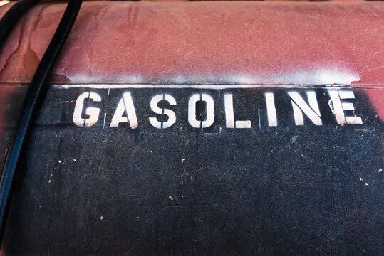 the word gasoline stenciled on an old tank