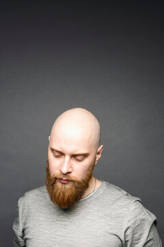 Portrait of bald man with red beard looking down