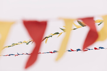 Festive Flags Hanging Over White Sky