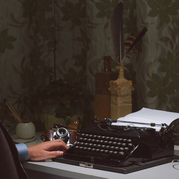 Vintage writer sitting at the typewriter